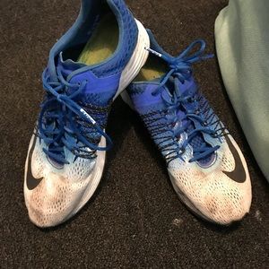 Blue and white nike running shoes
